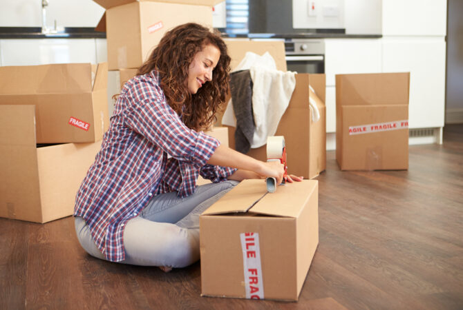 Woman packing moving box