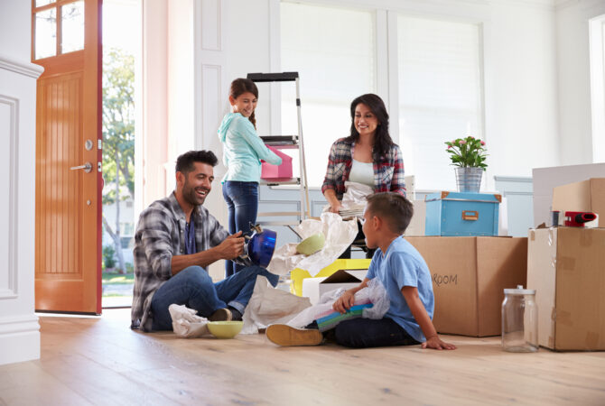 Young family packing up household items for move