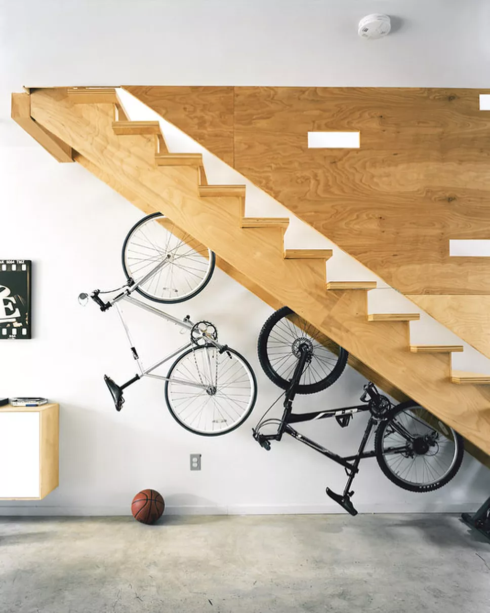 https://www.extraspace.com/blog/wp-content/uploads/2018/04/creative-under-stairs-storage-ideas-bikes-out-of-view.jpg.webp