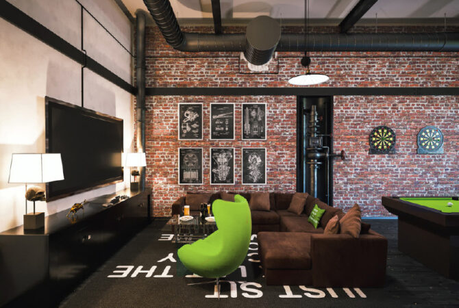 Industrial style game room with brick walls and modern furniture.