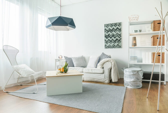 small living room inside a studio apartment with small love seat and chair