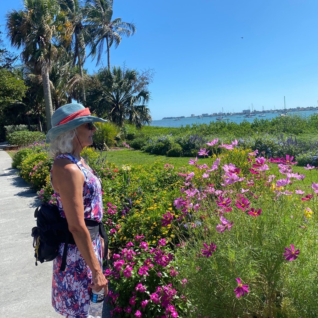 Active senior enjoying lush greenery and blooming flowers in Sarasota. Photo by Instagram user @michelle.schuman.58.