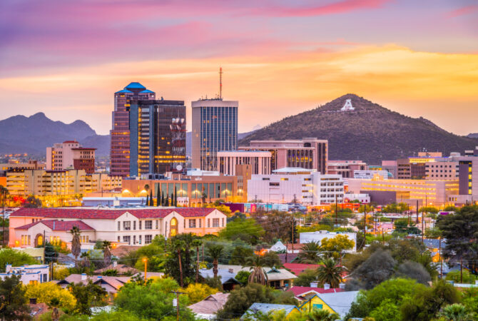 Skyline of tall buildings and a mountain during sunset in Tucson