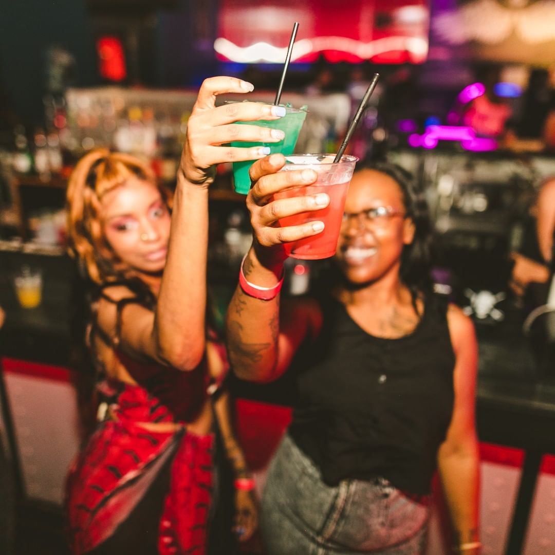 Two girls cheersing drinks at bar. Photo by Instagram user @powerplantlive