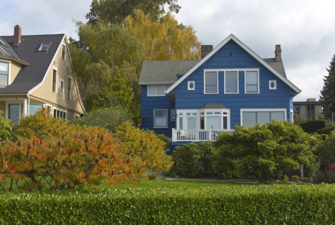 blue home with white shutters and nice landscaping in Seattle, WA