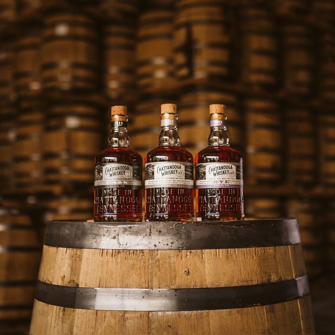 Three Bottles of Chattanooga Whiskey Sitting on a Barrel. Photo by Instagram user @chattwhiskey