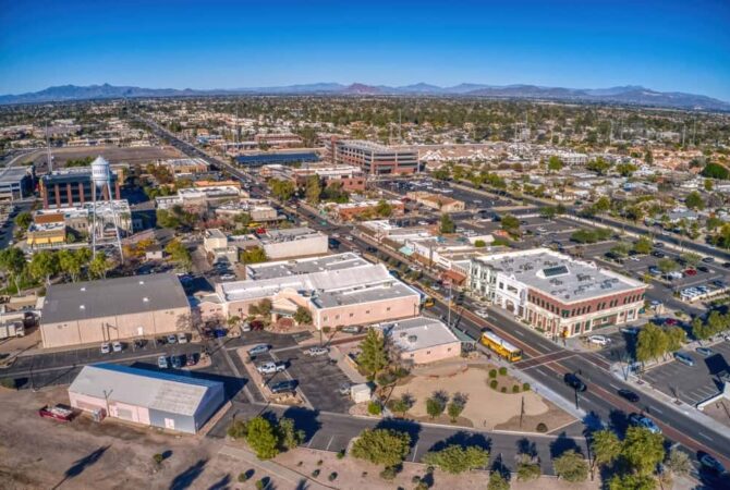 Aerial view of Phoenix suburb, Gilbert Arizona with flat roof buildings and paved streets in a clear day